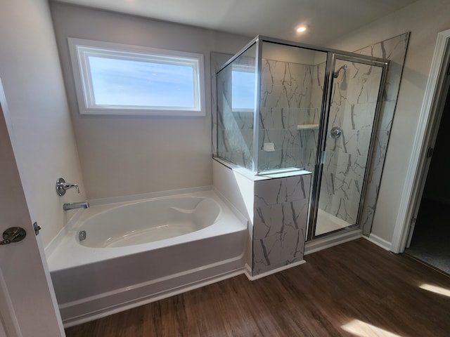 bathroom featuring hardwood / wood-style floors and plus walk in shower