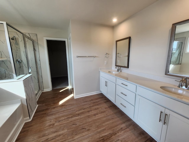 bathroom featuring hardwood / wood-style flooring, vanity, and an enclosed shower