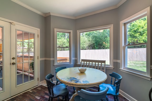 dining room featuring french doors, a wealth of natural light, and ornamental molding