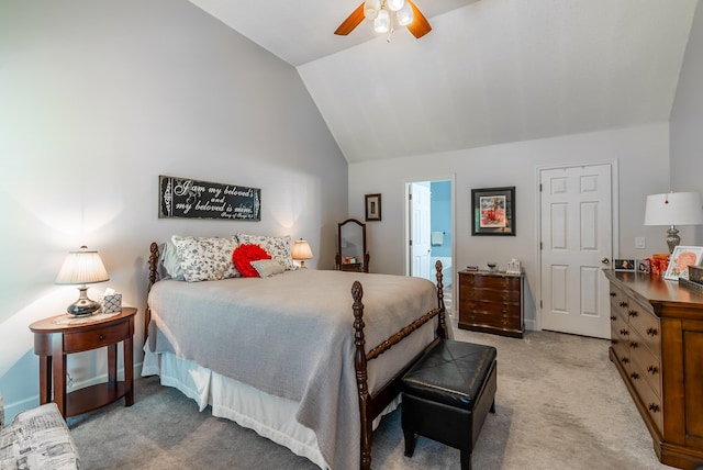 carpeted bedroom featuring vaulted ceiling, ceiling fan, and ensuite bathroom