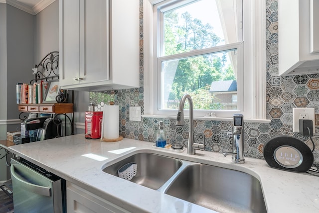 kitchen featuring dishwasher, white cabinets, light stone countertops, and sink