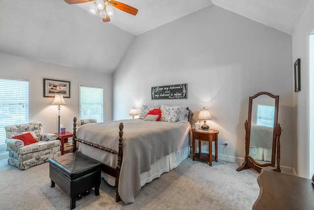 bedroom featuring vaulted ceiling, ceiling fan, and light carpet