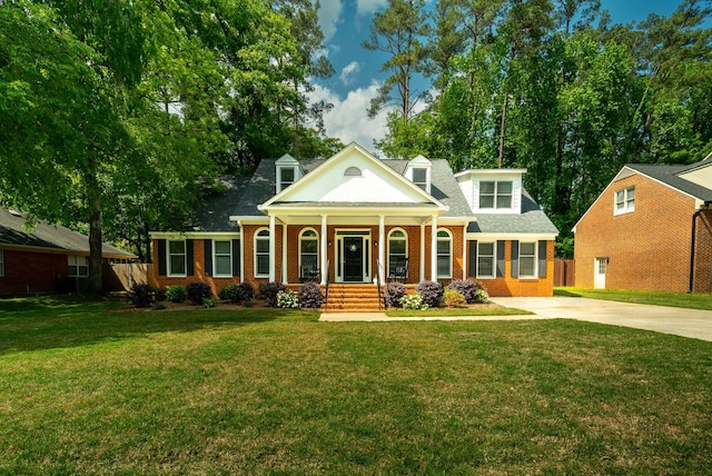 greek revival house featuring a front lawn and a porch