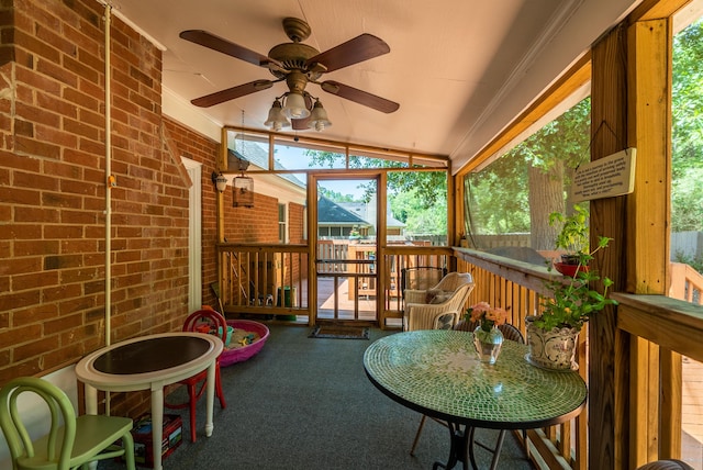 sunroom / solarium with ceiling fan and lofted ceiling