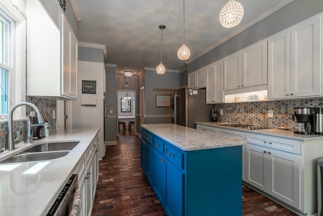 kitchen featuring backsplash, sink, and white cabinetry