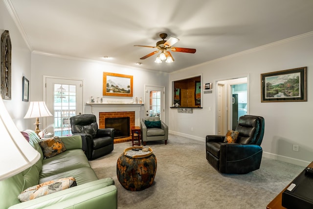 carpeted living room with ceiling fan, a fireplace, and crown molding