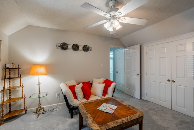 living room with vaulted ceiling, ceiling fan, and carpet floors