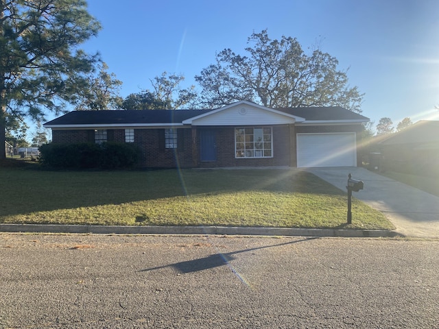 single story home featuring a front yard and a garage