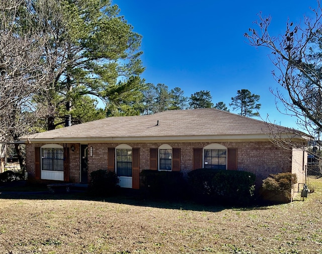 ranch-style home with a front lawn