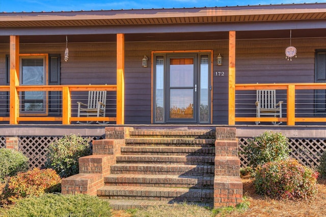 doorway to property with covered porch