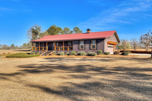 view of front of home with a garage and a porch