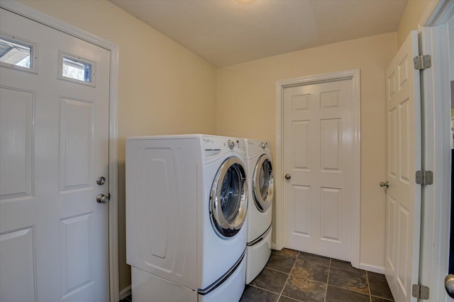 washroom with washing machine and clothes dryer