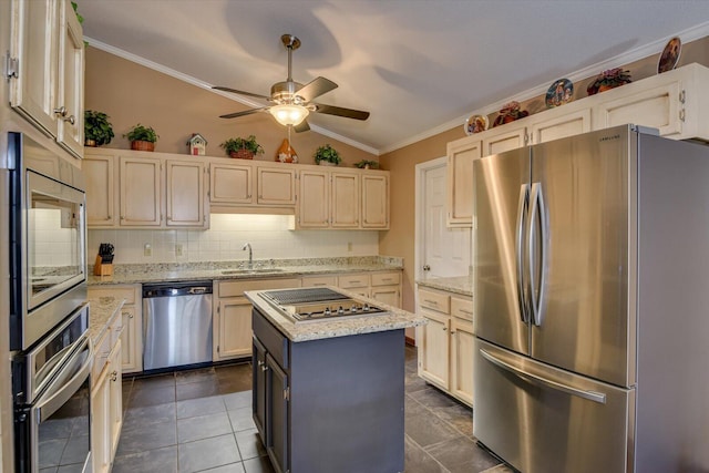 kitchen with appliances with stainless steel finishes, backsplash, lofted ceiling, a kitchen island, and sink