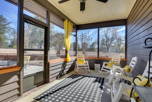 sunroom / solarium featuring ceiling fan