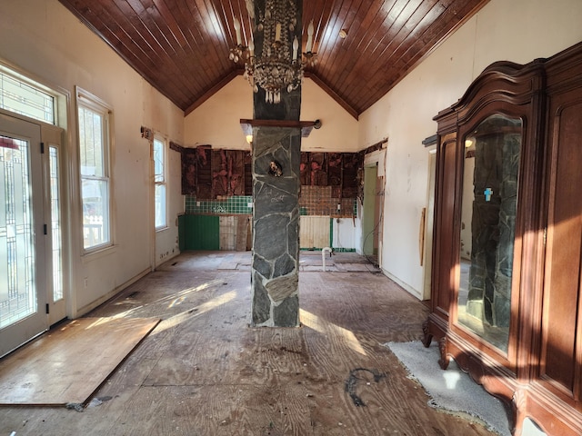 interior space with an inviting chandelier, wood ceiling, and high vaulted ceiling