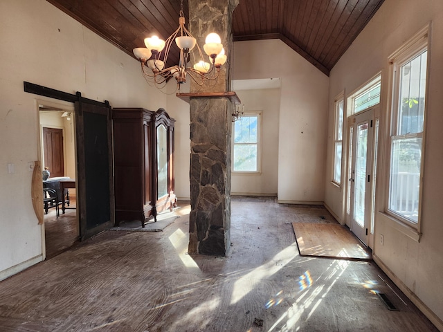 unfurnished dining area featuring a notable chandelier, a barn door, high vaulted ceiling, and wooden ceiling