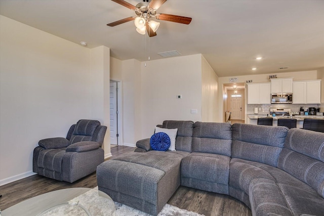 living room featuring dark hardwood / wood-style floors and ceiling fan