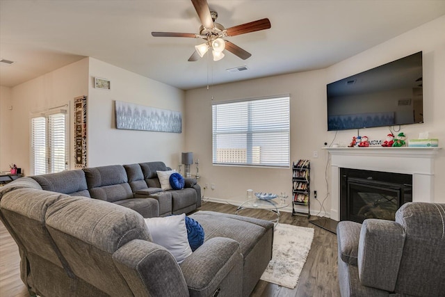 living room with ceiling fan and dark hardwood / wood-style flooring