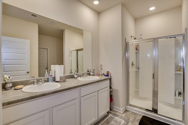 bathroom with vanity and a shower with shower door