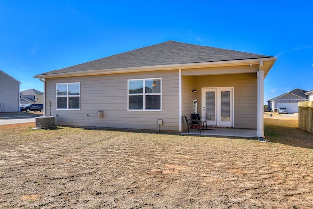 rear view of property with central AC unit and a patio