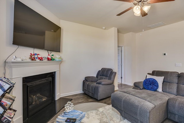 living room featuring ceiling fan and wood-type flooring