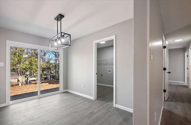 unfurnished dining area featuring wood-type flooring