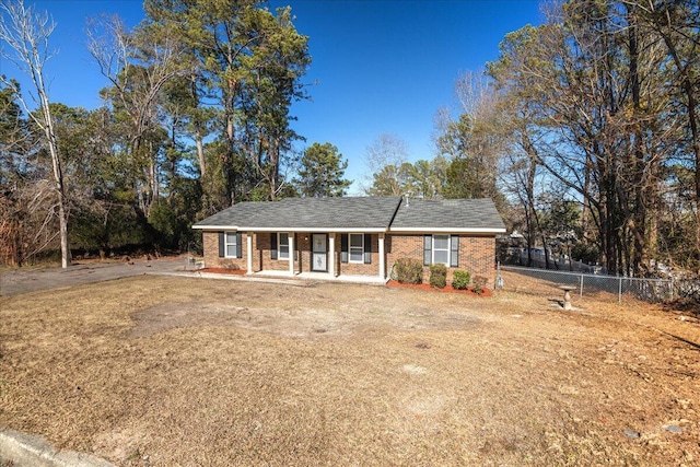 single story home with a porch and a front lawn