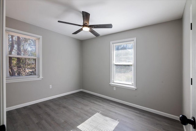 spare room featuring ceiling fan and dark hardwood / wood-style flooring