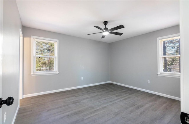 empty room featuring hardwood / wood-style flooring, a healthy amount of sunlight, and ceiling fan