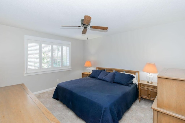 bedroom featuring ceiling fan and light colored carpet