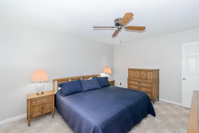 bedroom with ceiling fan and light colored carpet