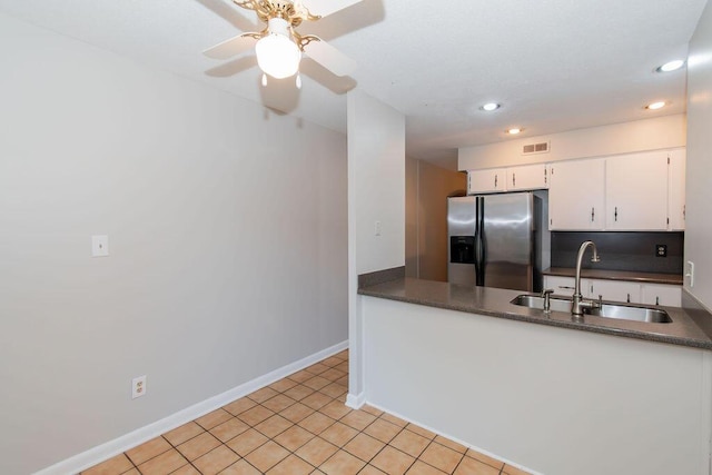 kitchen featuring white cabinets, sink, tasteful backsplash, light tile patterned flooring, and stainless steel fridge with ice dispenser