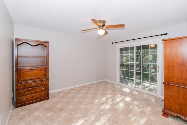 interior space featuring ceiling fan and light colored carpet