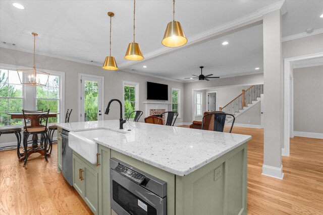 552 River Oaks Ln, Evans, GA 30809 - kitchen with green cabinetry, a sink, a fireplace, ceiling fan, and crown molding