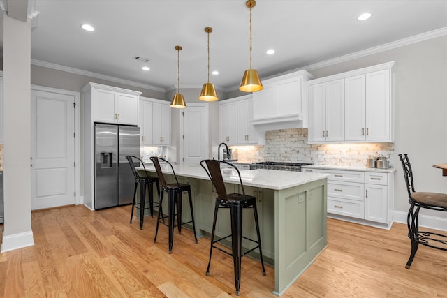 552 River Oaks Ln, Evans, GA 30809 - kitchen featuring stainless steel fridge, white cabinetry, a center island with sink, tasteful backsplash, and crown molding