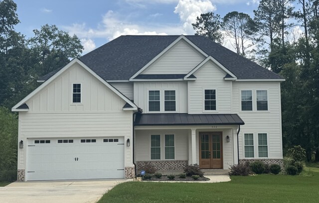 552 River Oaks Ln, Evans, GA 30809 - view of front of house with brick siding, concrete driveway, a front yard, french doors, and roof with shingles