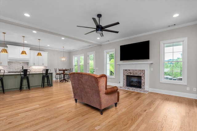 552 River Oaks Ln, Evans, GA 30809 - living area featuring light wood finished floors, a tile fireplace, a ceiling fan, recessed lighting, and baseboards