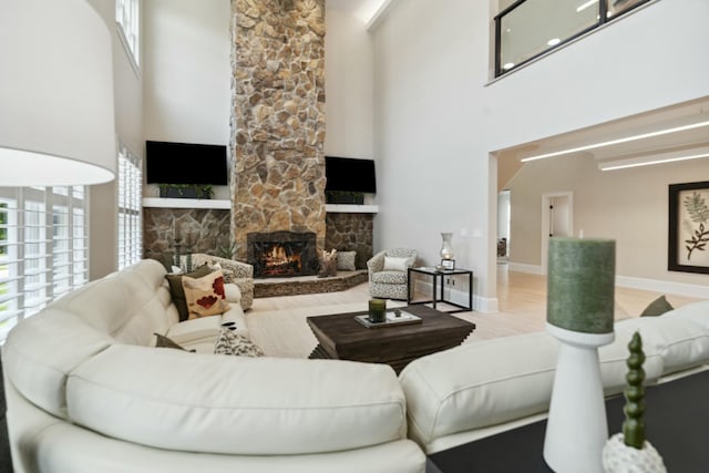 29 Savannah River Pl, North Augusta, SC 29841 - living room with baseboards, a stone fireplace, and a towering ceiling