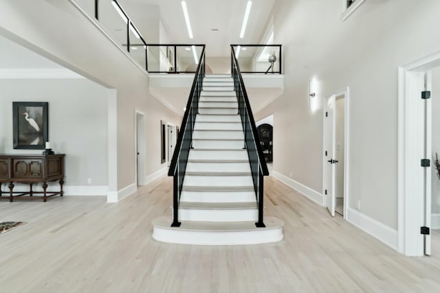 29 Savannah River Pl, North Augusta, SC 29841 - stairway featuring baseboards, wood finished floors, and a towering ceiling