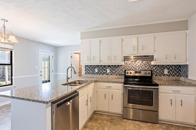 661 Kemper Dr, Evans, GA 30809 - kitchen with appliances with stainless steel finishes, under cabinet range hood, a peninsula, tasteful backsplash, and light stone counters