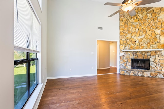 661 Kemper Dr, Evans, GA 30809 - unfurnished living room featuring a high ceiling, a ceiling fan, wood-type flooring, and a fireplace