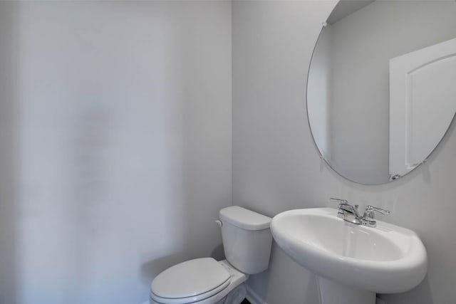 bathroom featuring toilet and sink