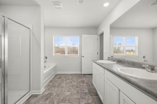 bathroom with vanity and plus walk in shower