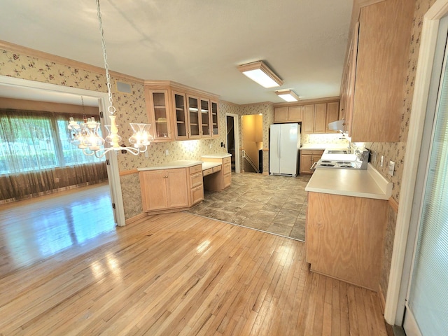 2023 Pisgah Rd, North Augusta, SC 29841 - kitchen with white appliances, light wood finished floors, light countertops, glass insert cabinets, and a chandelier
