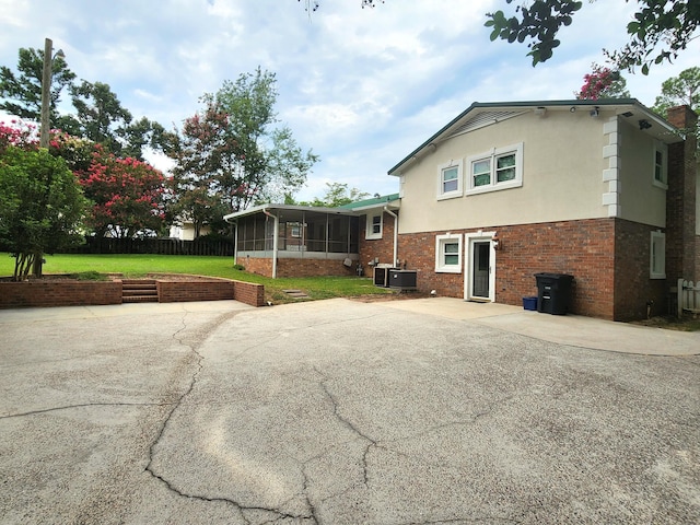 2023 Pisgah Rd, North Augusta, SC 29841 - back of property featuring a sunroom, a patio, stucco siding, and brick siding