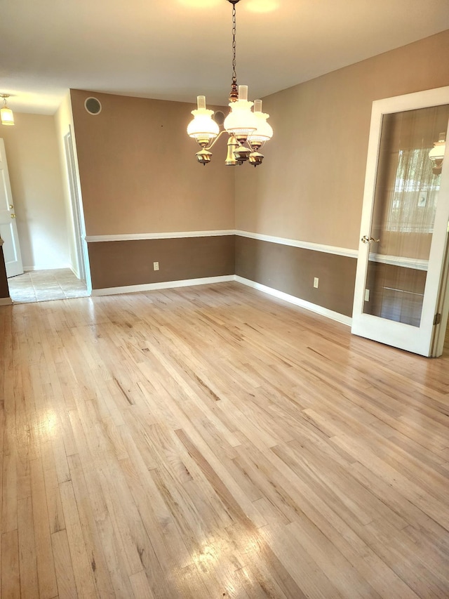 2023 Pisgah Rd, North Augusta, SC 29841 - spare room featuring light wood-style floors and a chandelier