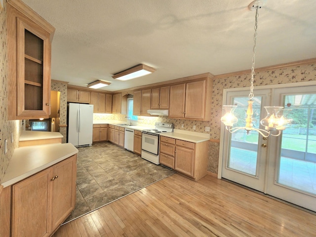 2023 Pisgah Rd, North Augusta, SC 29841 - kitchen featuring white appliances, wallpapered walls, light wood finished floors, a chandelier, and light countertops