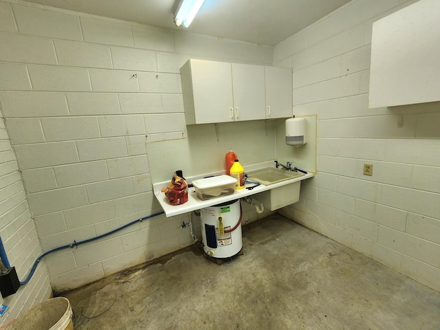 2023 Pisgah Rd, North Augusta, SC 29841 - kitchen with unfinished concrete flooring, white cabinets, light countertops, and concrete block wall
