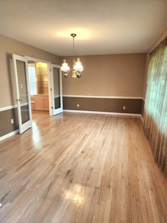 2023 Pisgah Rd, North Augusta, SC 29841 - spare room with light wood finished floors, a chandelier, and french doors
