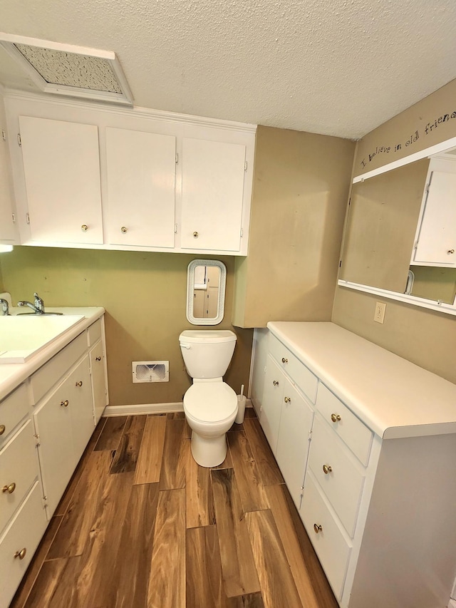2023 Pisgah Rd, North Augusta, SC 29841 - bathroom with vanity, wood finished floors, and a textured ceiling